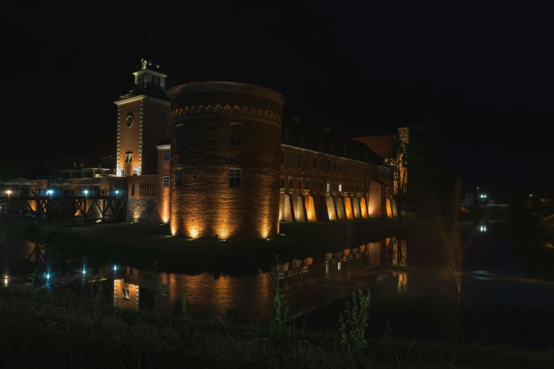 a long brick building that is lighted up in lights at night