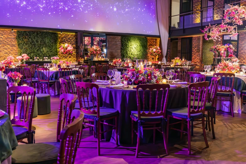 the table is set with white tablescloths and black chairs