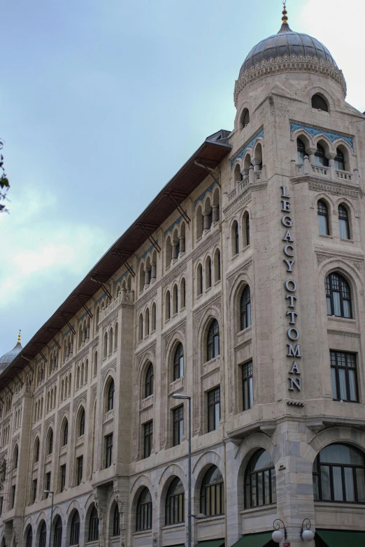 a tall building with a clock in the top corner