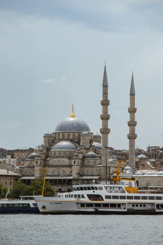 a large boat in front of a large, ornate building