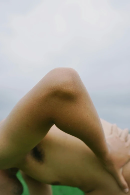 a woman is laying on the ground with her head above her back