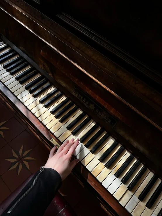 a woman playing the piano with her fingers