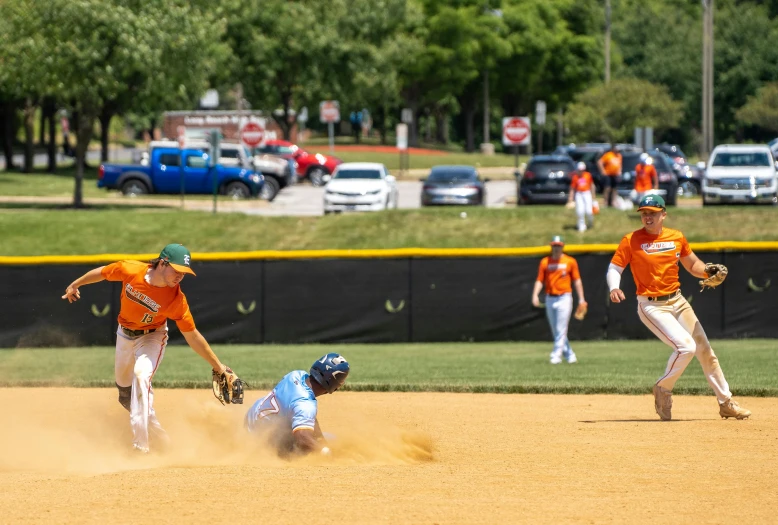 a baseball game showing two players trying to tag another player