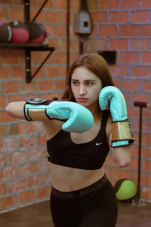 a girl wearing gloves holding her fists