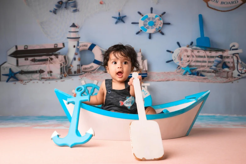 a young child poses for a pograph while inside a boat