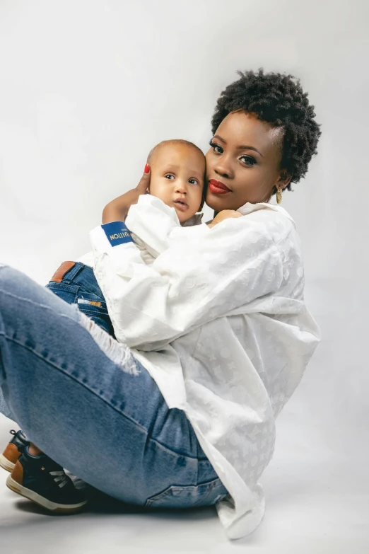 woman and baby are hugging and looking at camera