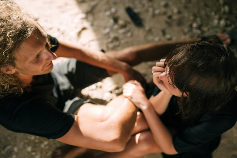 a man and a woman are touching their hands