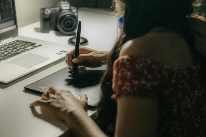 two people are using cell phones and laptops