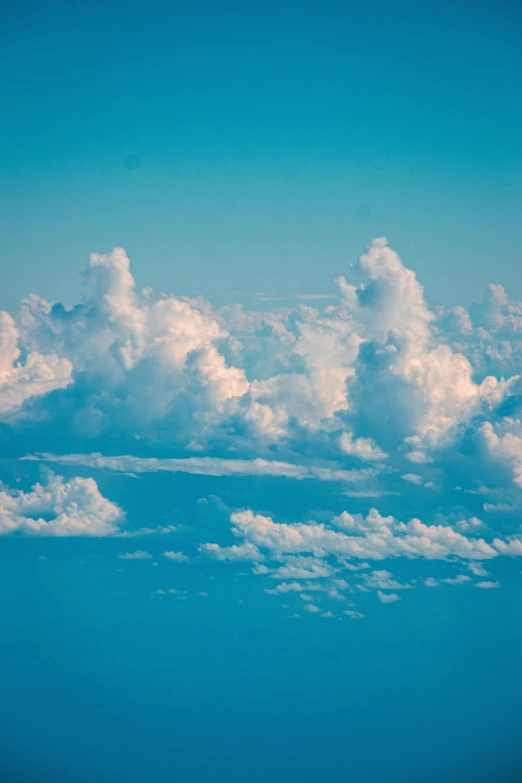 a view of a plane in flight above the clouds