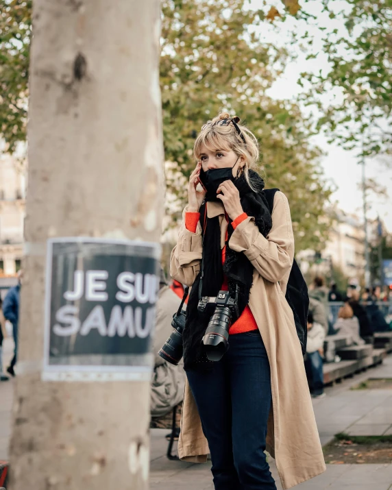 a woman in a brown coat is talking on her phone