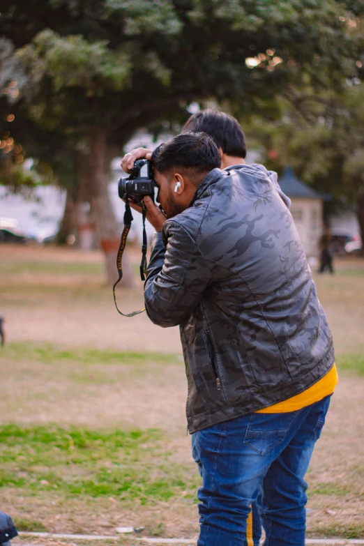 man taking pictures with his camera outdoors