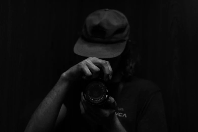 a person holding a camera with their hand up