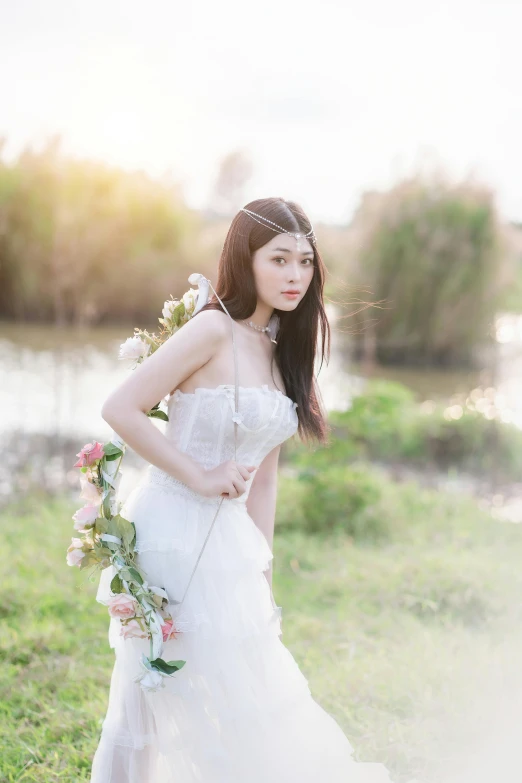 a woman in white dress posing for a po