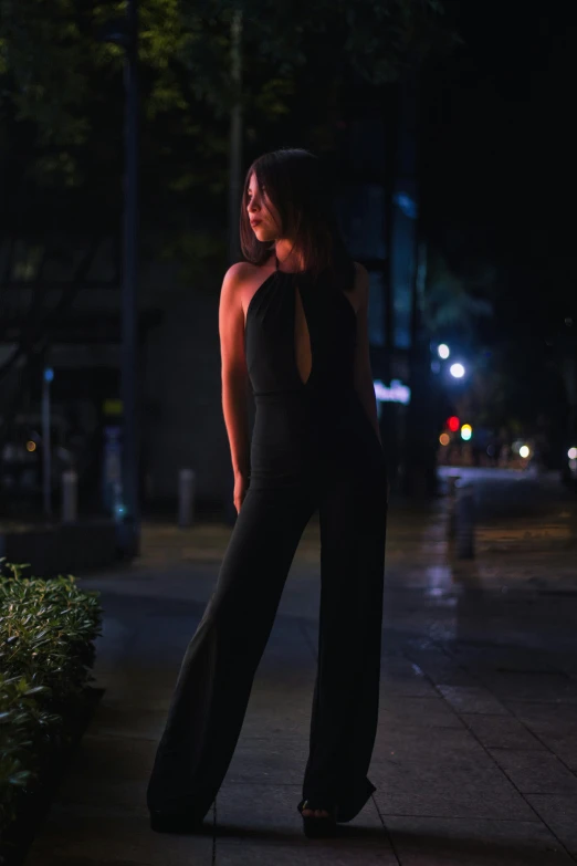 woman in evening outfit posing for picture on city street