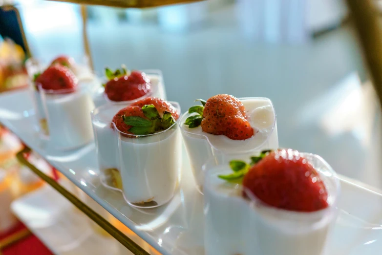 strawberries on small cups of a table