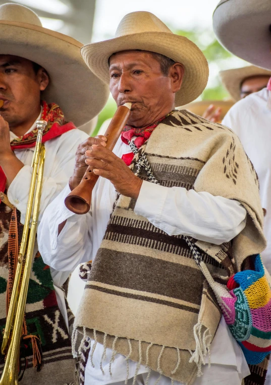 three people in mexican style hats are playing instruments