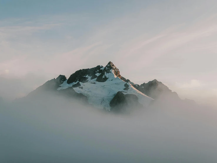 an image of mountains in fog with a sky background