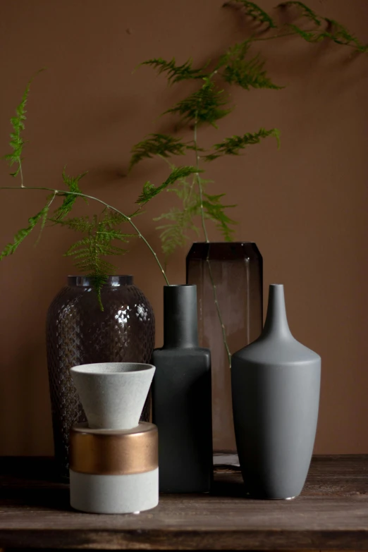 a close up of four vases on a table