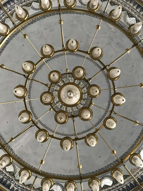 a ceiling made with gold metal objects inside a building