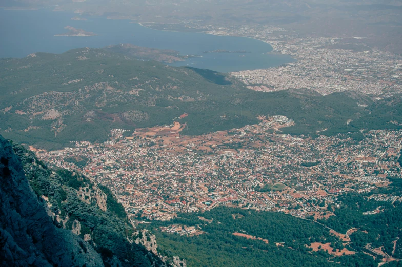 the city seen from above is located next to a mountain