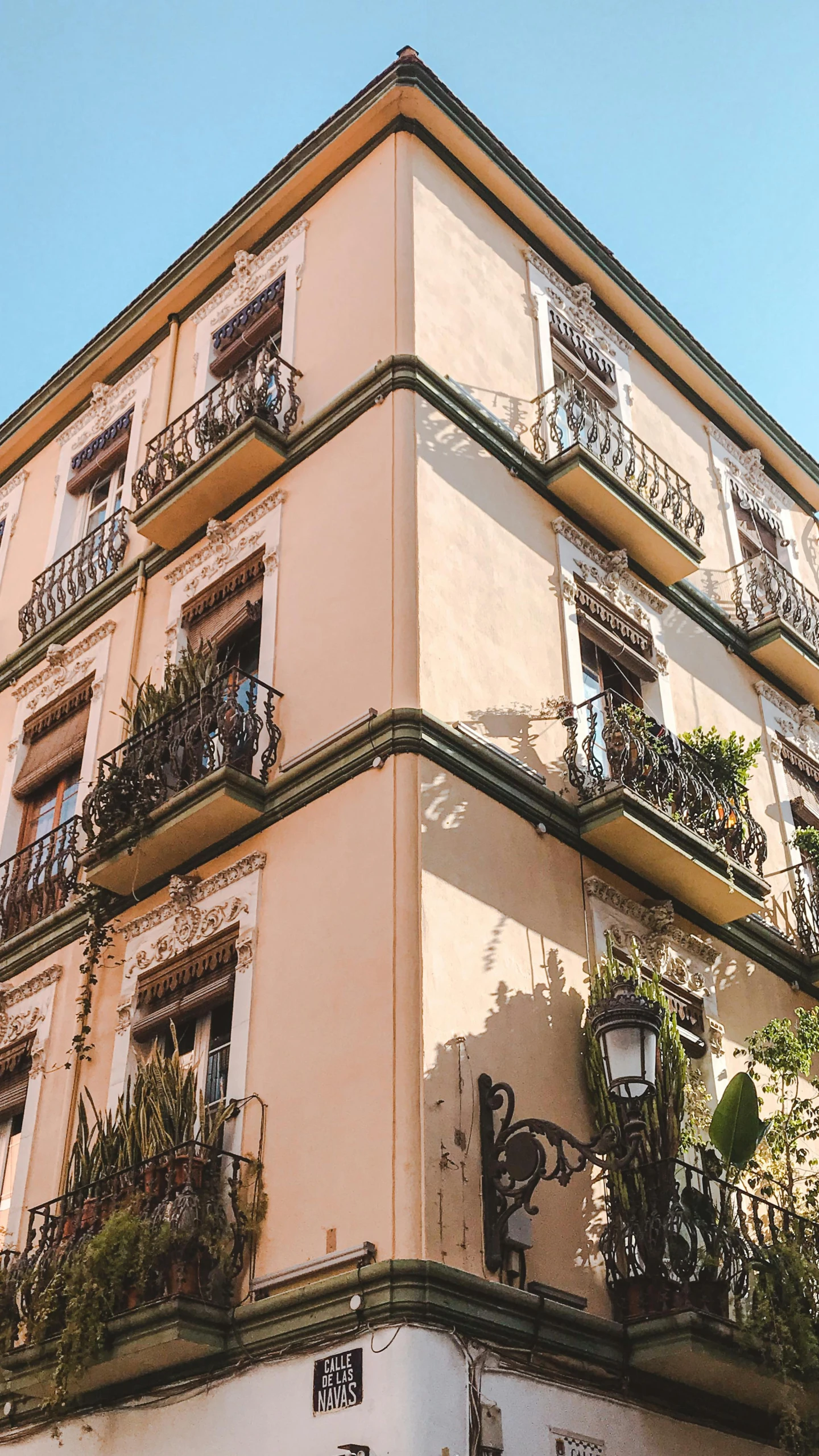 an old building with plants and balcony balconies