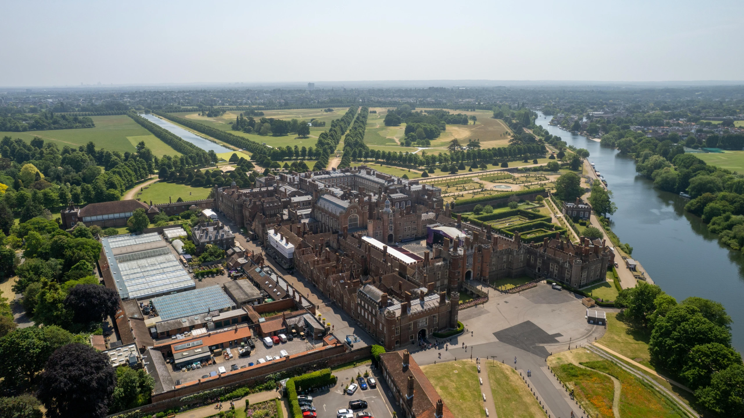 an aerial view of an historic country house with buildings and gardens