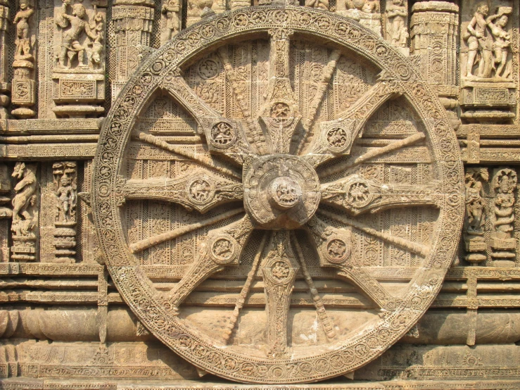 a wheel on the front of an ancient building