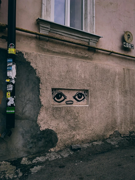graffiti that looks like eyes is on the side of a building