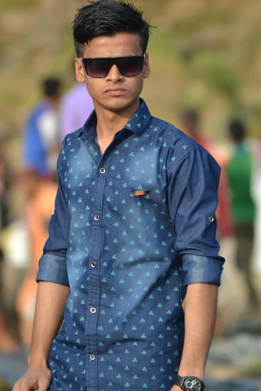 man wearing sunglasses and blue patterned shirt