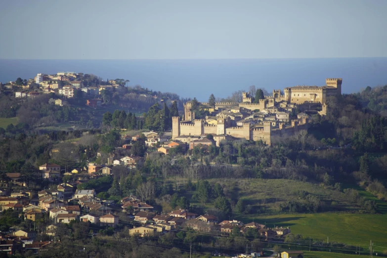 there is a large castle on the hill next to some houses