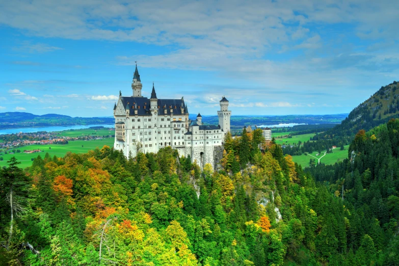 a castle overlooking a valley near the water