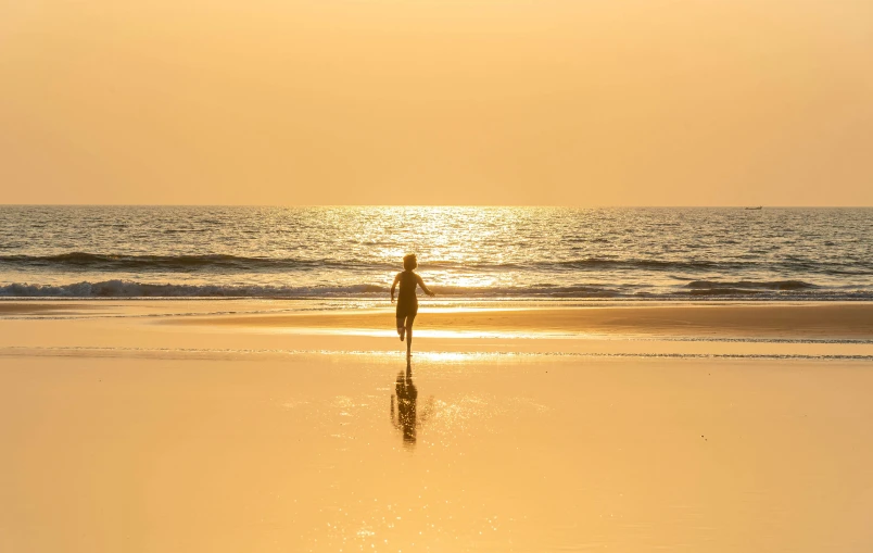 a person standing in the ocean while looking down