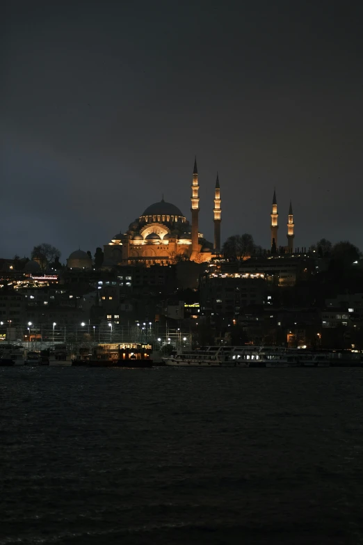 a large mosque and city lit up at night
