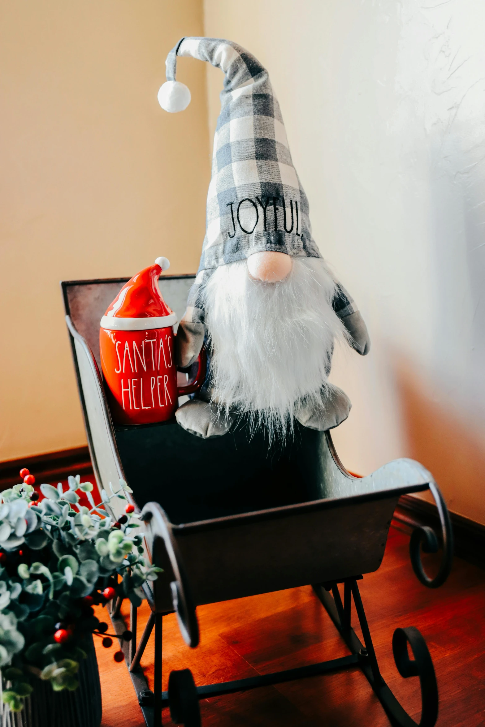 gnome holding a bucket on his head sitting in a wheelbarrow