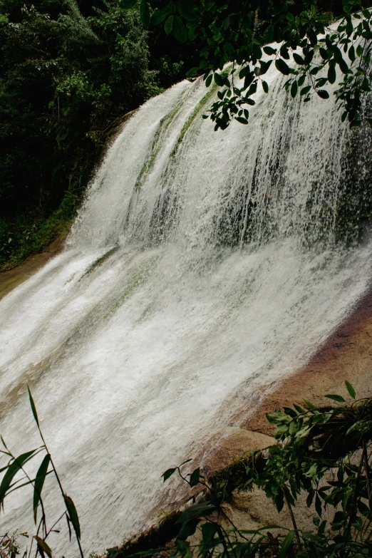 the base of a small waterfall with water falling
