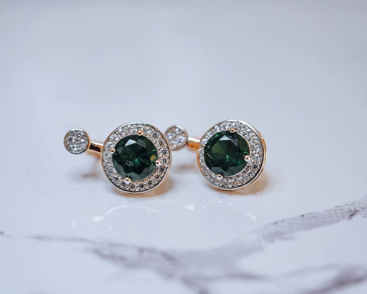 a close up of two green gems