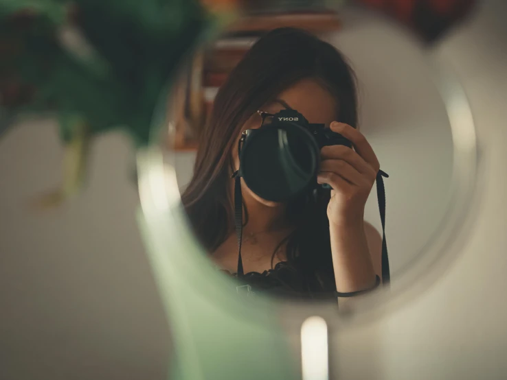 a woman taking a selfie in front of a mirror