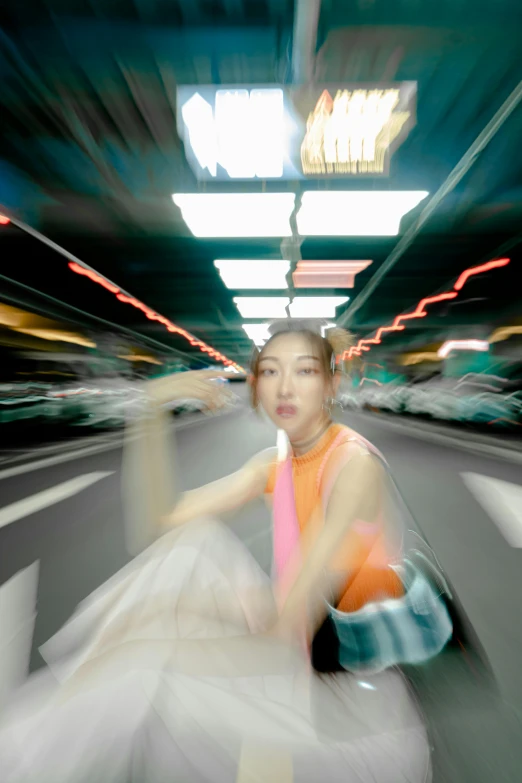 a girl is sitting on the road in an underpass