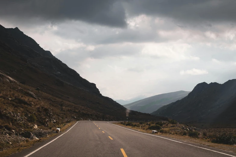 a car going down an empty mountain road