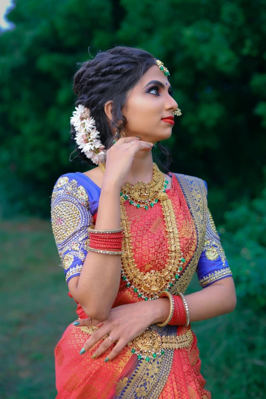 the beautiful indian woman in her traditional dress poses for the camera