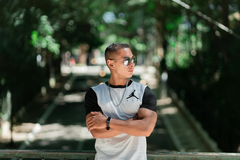 a person with his arms crossed wearing sunglasses