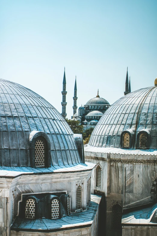 two domes shaped like buildings with a sky background