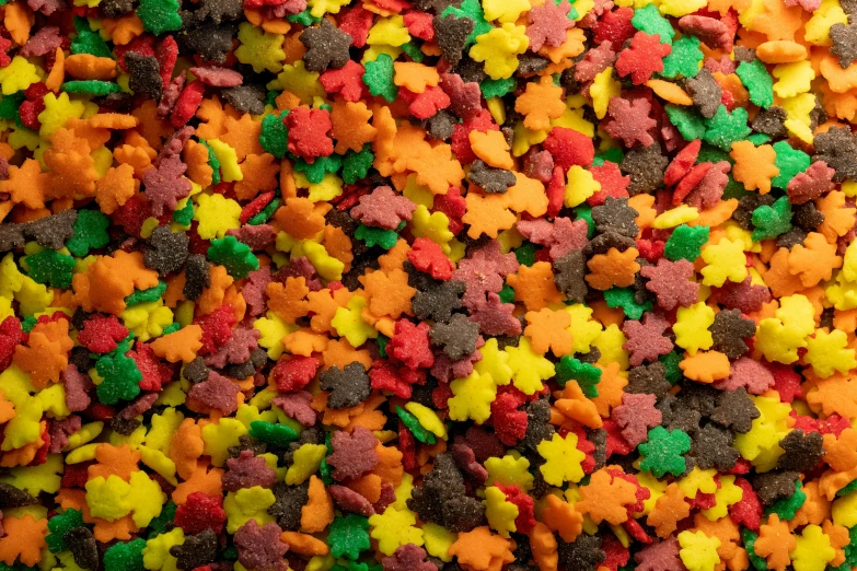 a mixture of various colored dog treats next to each other