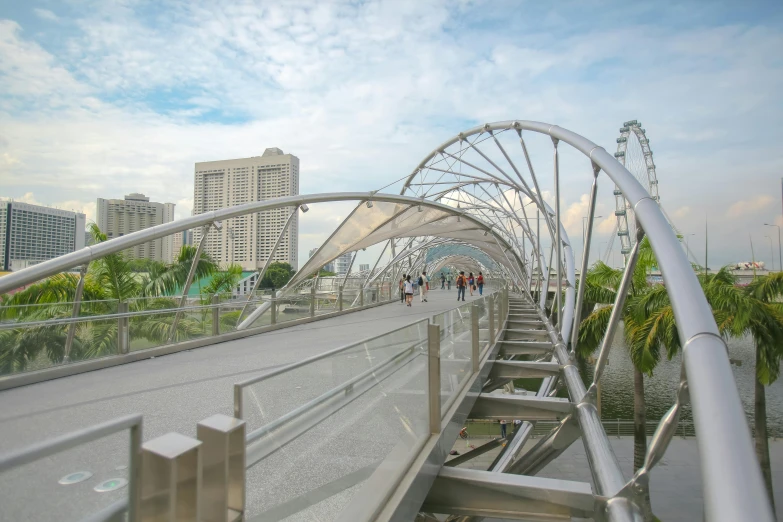 a large white curved bridge near a city