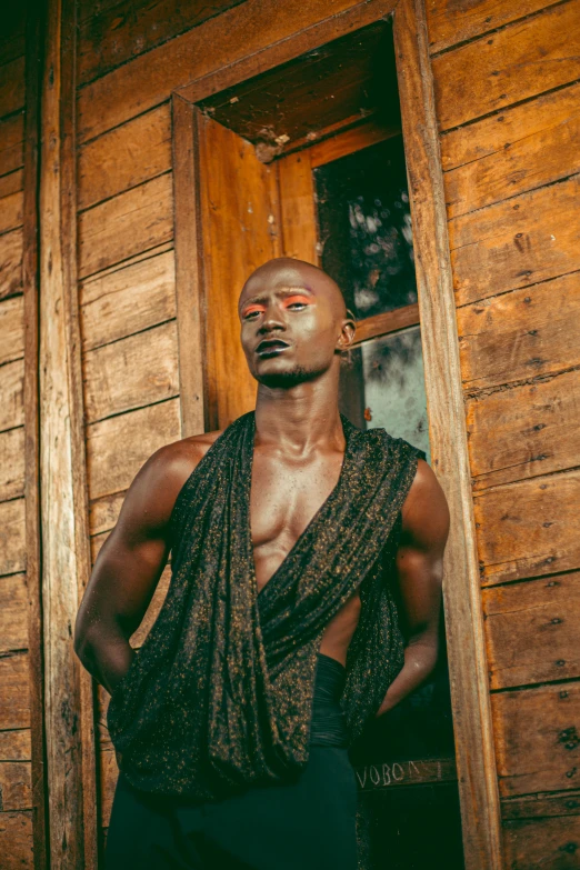 a shirtless man wearing an old looking shirt