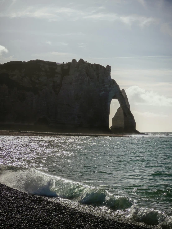 a sandy beach next to some water