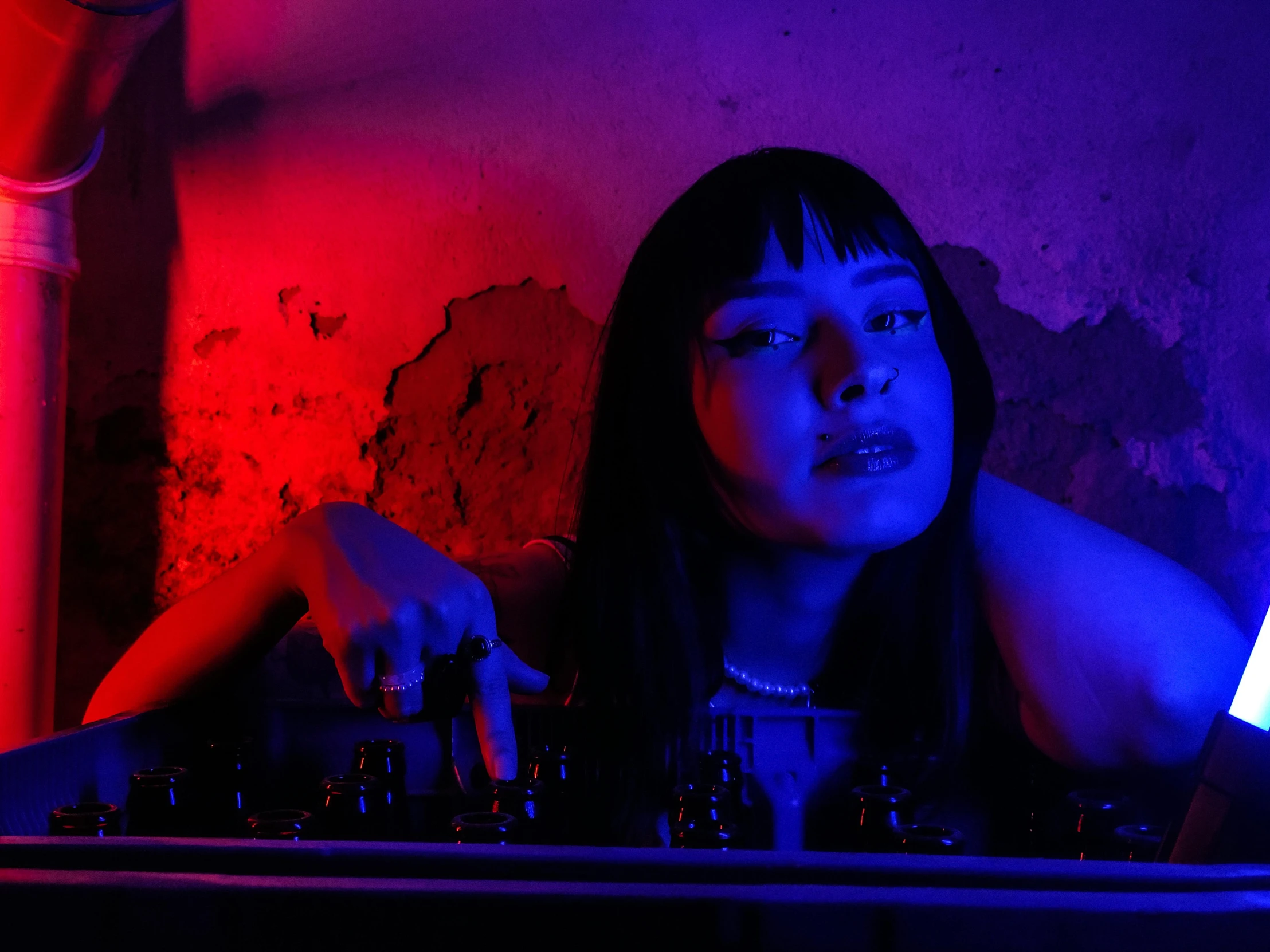 a girl playing a dj set in the dark