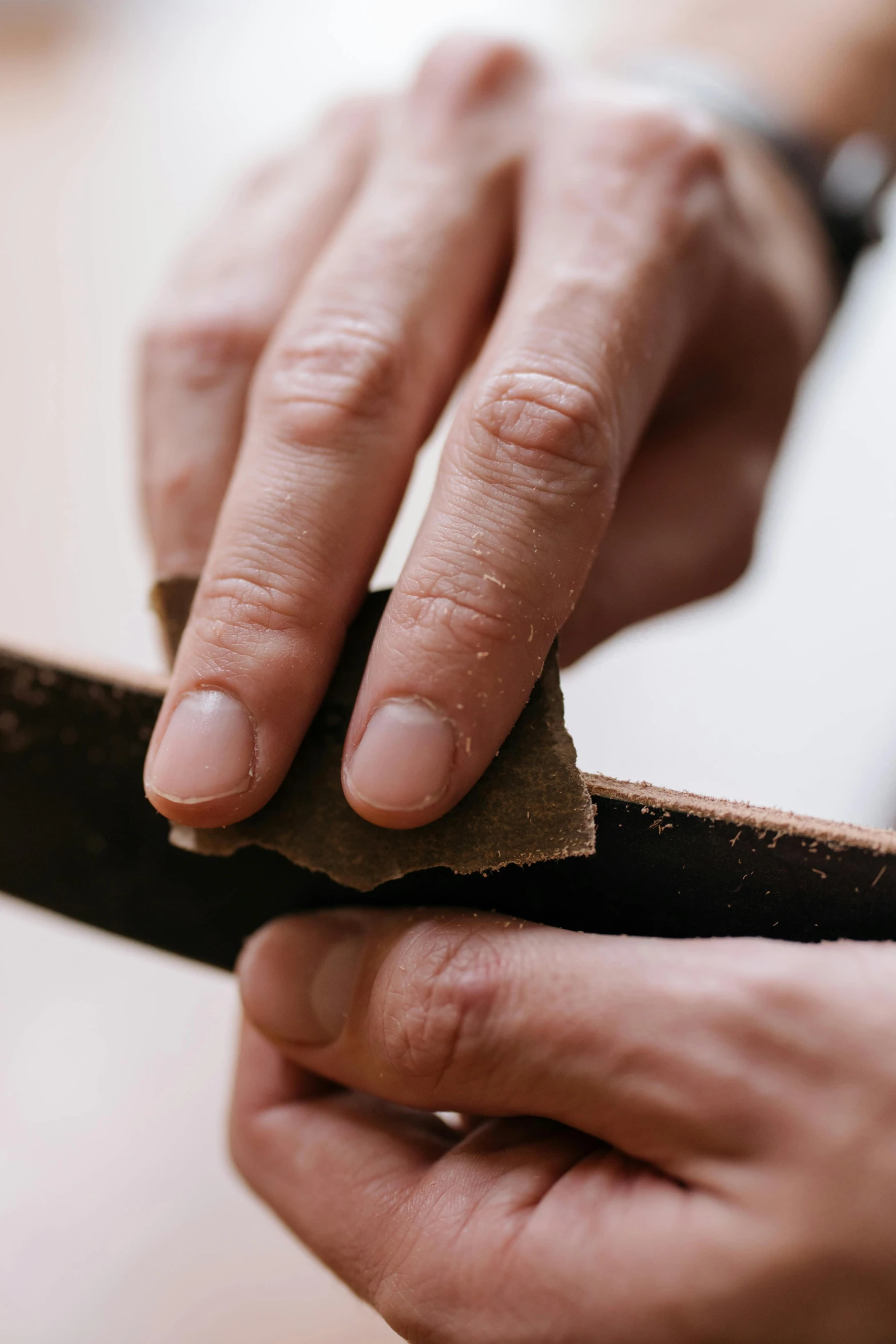 someone is using an old knife with cloth around it