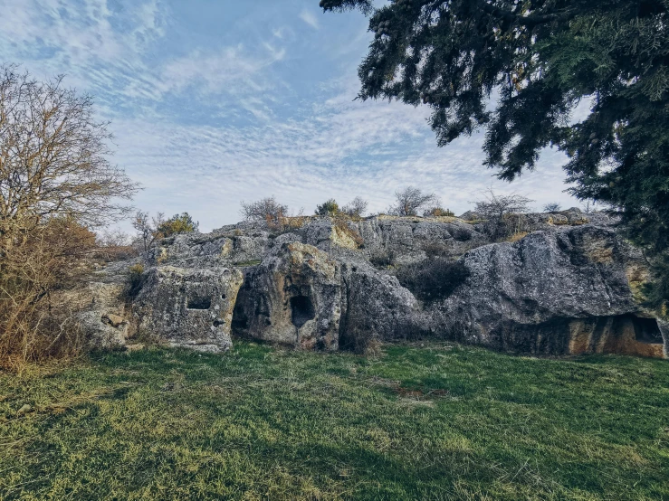 a building in a grassy area next to some trees