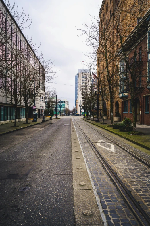 a small road in a city with tall buildings